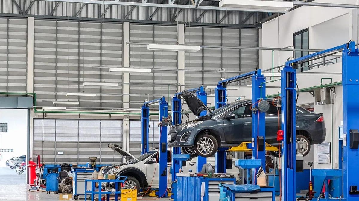 A franchised dealership service workshop with vehicles on lifts